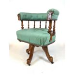 A Victorian captains chair on metal and ceramic castors with button back upholstery. Seat height.