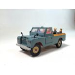Vintage Britains No. 9676 Farm Land Rover with seated figures and steering from spare wheel to rear.
