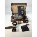 A box of vintage camera lenses, filters and fittings. Box dimensions W:34cm x D:35cm