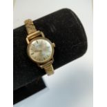 9 ct gold wristwatch by Rotary, ladies weight of 4g. Swiss made with 21 jewel movement. Stretch link