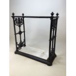 A cast iron umbrella stand with twelve sections and removable drip tray W:65cm x D:29cm x H:60cm