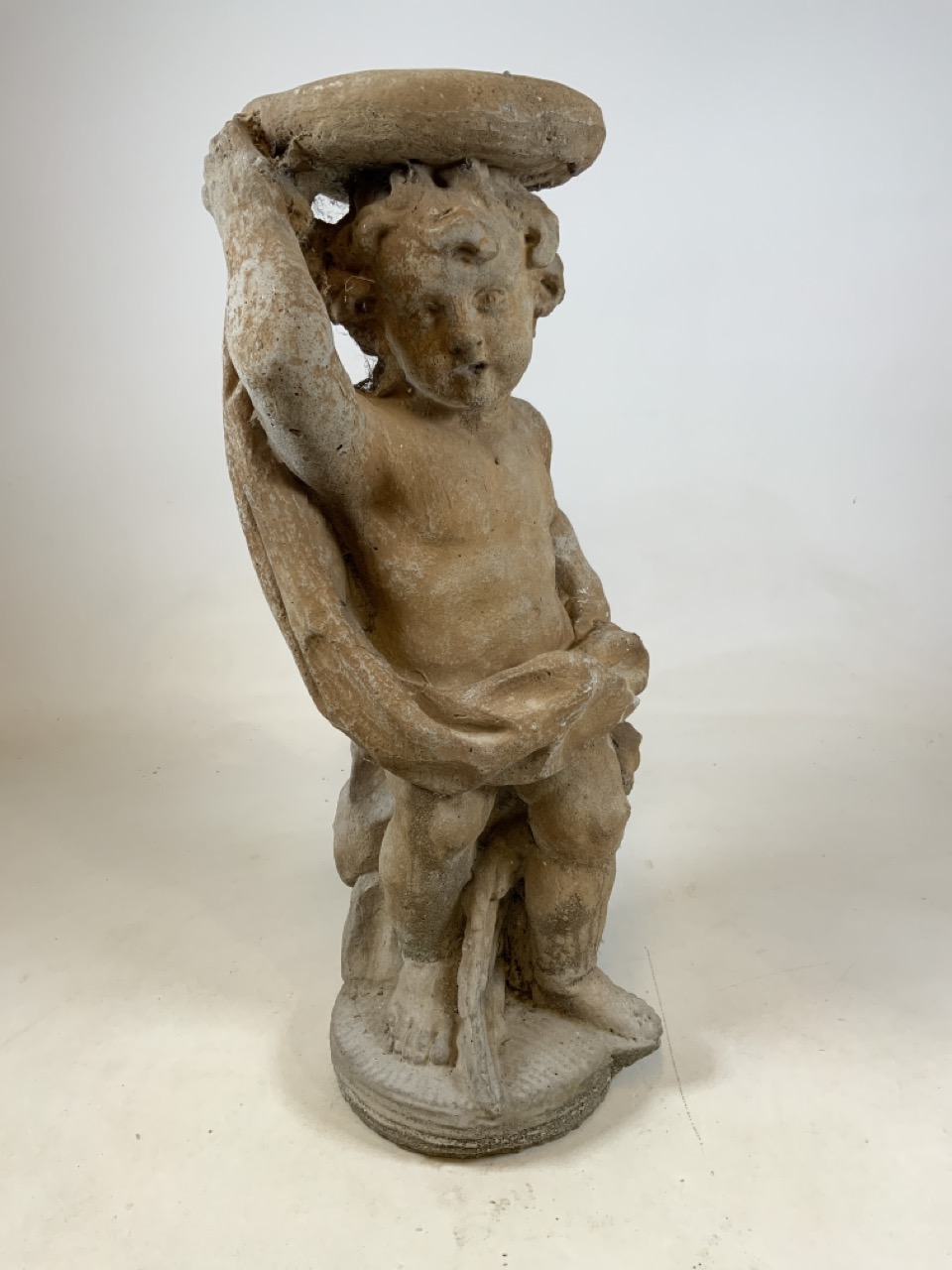 A reconstituted stone jardiniere statue of a cherub.