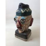A french vintage painted head with glass eyes - great for the garden