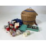 A mid century wicker sewing basket also with a selection of accessories.