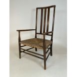 An arts and craft oak rush seated country arm chair. Seat height H:30cm. W:49cm x D:46cm x H:89cm