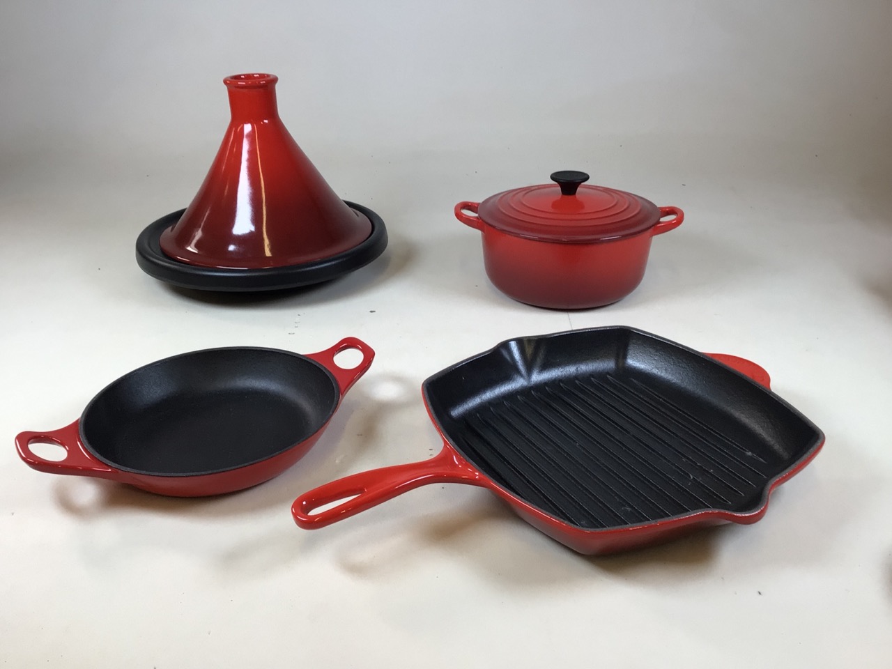 A Le Creuset tagine, griddle pan and casserole dish (20cm width) together with another dish