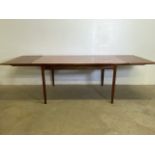 A teak mid century G Plan extendable table with two pull out leaves and tapered legs. Extended W: