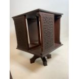 A Small table top revolving bookcase with carved details. W:30cm x D:30cm x H:40cm