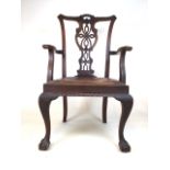 A large mahogany chippendale style chair with detailed carved back and large ball and claw front
