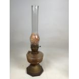 An oil lamp on wooden base H:22.5cm