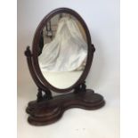 An early 20th century oval dressing table mirror. W:70cm x D:29cm x H:77cm