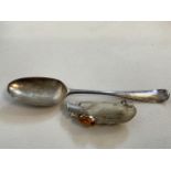 A silver spoon 28 grams also with a rabbits foot brooch with antler head detail.