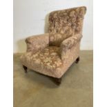 A small Victorian Howard style arm chair with turned mahogany legs with brass and ceramic castors.