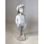 White plaster figure of a young farm boy. In jovial whistling pose. Small loss to shoe. W:17cm x D: