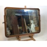 A late 19th early 20th century curved edge oak and gilt mirror. W:70cm x H:50cm