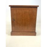 A small mahogany lockable cupboard with key, interior with three brass handled drawers below