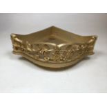 A gilt corner shelf with decorative front