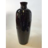A large black glazed earthenware urn shaped pot W:24cm x H:67cm