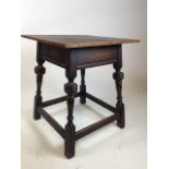 An oak lamp table with square top and cupped bannister legs - label to base G Hardy and co W:43cm