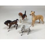 A collection of Beswick animals including Wendover Willy Beagle, Jovial Roger Greyhound and two