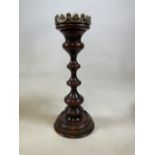 A large turned mahogany ecclesiastical style canlestick with later metal top. H:46cm