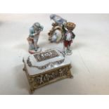 A Capodimonte footed lidded ceramic box decorated with children together with three decorative