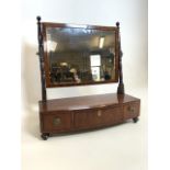 A Mahogany bow fronted dressing table mirror with three drawers to front. W:52cm x D:22cm x H:56cm