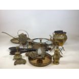 A quantity of brass items including trivets, candlesticks, a kettle, a mirror and other items. (
