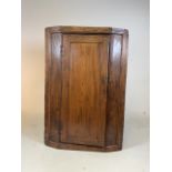 An oak and elm corner cupboard.