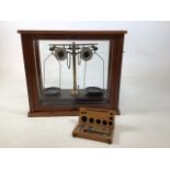 A set of scientific scales with boxed weights by Griffin & George Ltd W:45cm x D:23cm x H:40cm