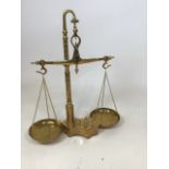 A set of brass scales complete with Weights built into base W:48cm x H:56cm