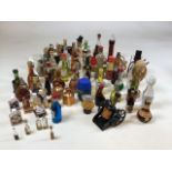 A collection of alcoholic miniatures including ceramic Beswick animals