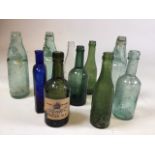 A collection of coloured glass bottles including Blue glass hair reviver, Starkey Knight and Ford