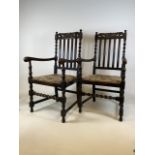 A pair of oak 19th century arm chairs with barley twist stretcher bars and carved details. W:55cm