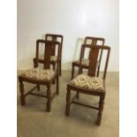 A set of four oak dining chairs with upholstered seats