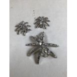 Spider brooch and earrings with diamante stones set within white metal by paste. Brooch missing