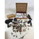 A box of costume jewellery and ebony dressing table items including hand mirrors
