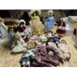 A quantity of unboxed collectors dolls tallest of which is approx 56cm. Includes a possible doll