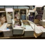 Ten Ashton Drake Galleries porcelain headed dolls in original boxes and packaging. Including