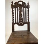 A carved oak chair with barley twist legs and carved back and set. Evidence of wood worm W:45cm x