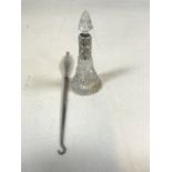 A Silver handled button hook. Marked P and a silver topped scent bottle.,