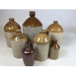 A collection of stoneware flagons including local interest Tiverton, Bridgwater, Taunton flagons and