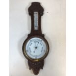 A British made oak cased early 20th century barometer and thermometer. H:61cm