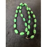 A jadeite necklace. Length 76cm
