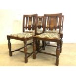 A set of four oak chairs with upholstery seats with bent wood backs and turned legs.