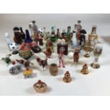 A collection of miniatures including filled glass animals