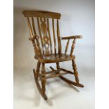 A 20th century pine rocking chair W:69cm x D:85cm x H:110cm