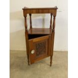 An early 20th century pot cupbard with galleried top and shelf above cupboard with carved door. W: