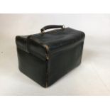 A vintage green leather toiletry case fully lined and stamped Harrods with brass fitting to top W: