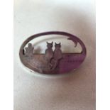 A silver cat brooch of a roof top scene. Stamped silver to reverse W:6cm x H:4cm